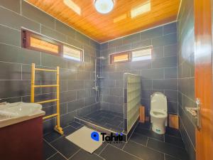 a bathroom with a toilet and a sink at Moorea Here Lodge house in Atiha +30 photos