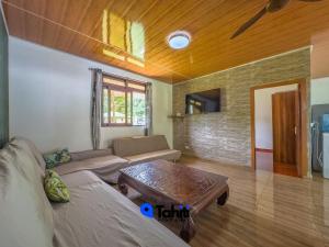 a living room with a couch and a coffee table at Moorea Here Lodge house in Atiha