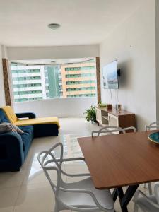 a living room with a couch and a table at Ocean Tower in São Luís