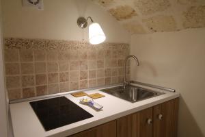 a kitchen with a sink and a counter top at HolidayMonopoli in Monopoli
