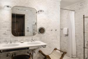 a bathroom with two sinks and a mirror at The Beekman, A Thompson Hotel, by Hyatt in New York +55 photos