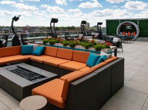 a rooftop patio with couches and tables on a building at Hyatt Place Chicago Wicker Park in Chicago