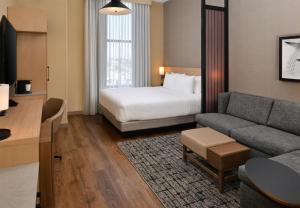 a hotel room with a bed and a couch at Hyatt Place Chicago Wicker Park in Chicago +44 photos