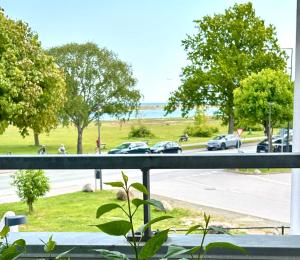 a view from a balcony with cars on the road at Seafront Lux Apt, Central, Beach, Direct Airport Metro in Copenhagen