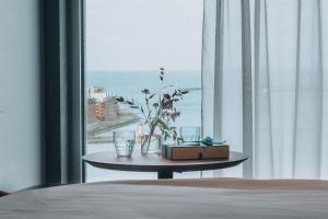 a room with a bed and a table with a window at STORY HOTEL MALMO, in JdV by Hyatt in Malmö +62 photos