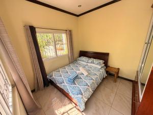 a bedroom with a bed and a window at Camotes Serenity in Camotes Islands