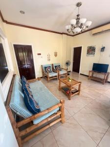 a living room with couches and a table at Camotes Serenity in Camotes Islands