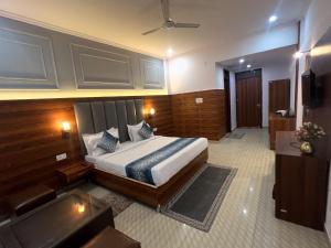 a hotel room with a bed and a television at Hotel Black Stone Palace in Ghaziabad