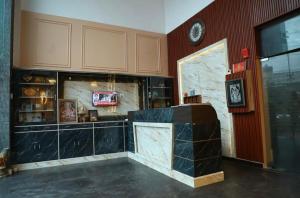 a room with a counter and a clock on a wall at Hotel Black Stone Palace in Ghaziabad