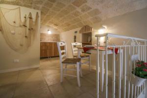 a kitchen and dining room with a table and chairs at HolidayMonopoli in Monopoli