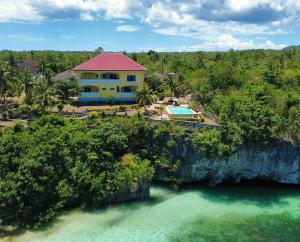 an aerial view of a house on a cliff over the water at Camotes Serenity in Camotes Islands