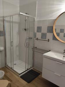 a bathroom with a shower and a sink at Appartamento Velocipede in Cervignano del Friuli +11 photos