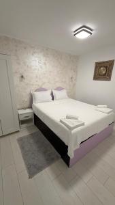a bedroom with a large bed in a room at Sab Luxury Apartments in Saturn