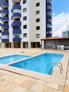 a swimming pool in front of a building at Ocean Tower in São Luís