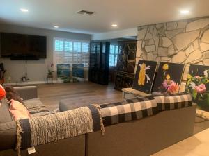 a living room with a couch and a stone fireplace at Spacious 3 bedrooms 1 bath Jacuzzi BBQ SINGLE HOUSE in Agoura Hills