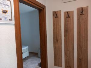 a bathroom with three wooden doors and a mirror at Къща за гости "НА СЕЛО" Грохотно in Devin +49 photos