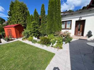 a garden with trees and a house at ​Gästehaus Frans-Jozef in Mönichkirchen