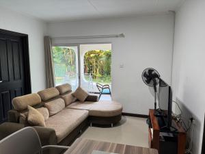 a living room with a couch and a table at Paul's Residence in Mahe