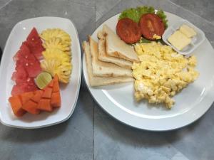 two plates of breakfast foods on a table at Bukit Luwih House in Munduk