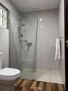 a bathroom with a shower and a toilet at Paul's Residence in Mahe +40 photos