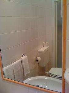 a bathroom with a tub and a toilet and a mirror at Hotel Villa Bianca in Laigueglia +9 photos