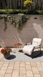 a chair sitting on a rug next to a table at Spa Villa Smetovi with Jacuzzi & Sauna in Zenica +17 photos