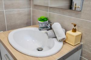 a white bathroom sink with a soap dispenser on it at Superbe appartement centre Montluçon, proche hôpital in Montluçon