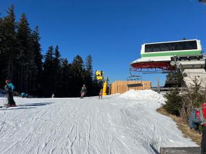 a group of people on a ski lift in the snow at ​Gästehaus Frans-Jozef in Mönichkirchen