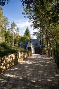 a brick road with a stone wall and a building at Spa Villa Smetovi with Jacuzzi & Sauna in Zenica