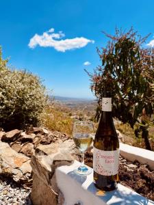 a bottle of wine sitting next to a glass at Casa Gaïa in Borge