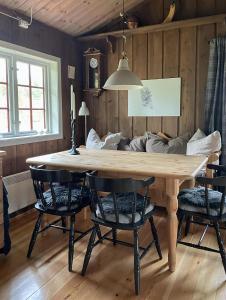 a dining room with a wooden table and chairs at Cabin With Rauland Mountain Views in Rauland