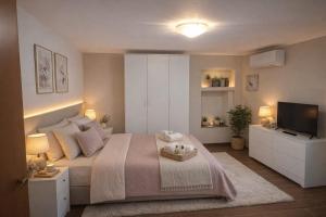 a bedroom with a large bed and a television at AFFITTACAMERE Gold in Barletta