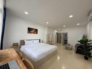 a bedroom with a bed and a table and a laptop at S hostel 302 sukhumvit48 near Phrakanong BTS in Amphoe Phra Khanong