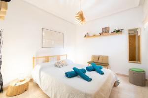 a bedroom with a bed with blue pillows on it at Can Tomeu in Calas de Mallorca +19 photos
