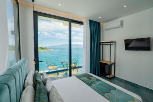 a hotel room with a couch and a view of the ocean at Siro Kerma Private Beach Villa in Sarandë +165 photos