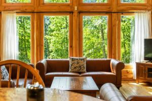 a living room with a couch and a table at Fiddler Lake Resort - Deer 79 in Mille-Isles