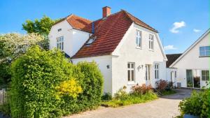a white house with a red roof at Nybo House in Præstø