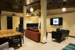 a living room with a couch and a table and chairs at Valhalla Villa in Panvel