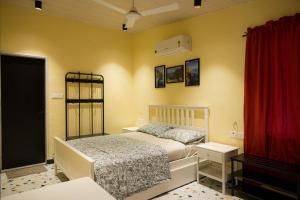 a bedroom with a bed and a red curtain at Valhalla Villa in Panvel +23 photos