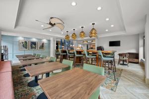 a dining room with wooden tables and chairs at Hampton Inn Naples - I-75 in Naples