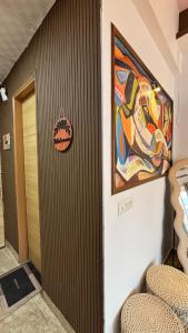 a painting on the wall of a hallway at Golden Nest Stays in Ghaziabad