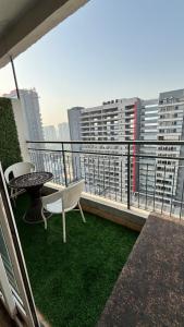 a balcony with a table and chairs on a balcony at Golden Nest Stays in Ghaziabad