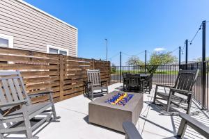 a patio with two chairs and a fire pit at Hampton Inn & Suites Scottsburg in Scottsburg