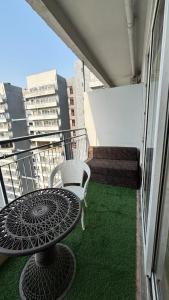 a balcony with a table and chair on a building at Golden Nest Stays in Ghaziabad
