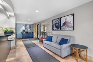 a living room with a couch and a table at AmericInn by Wyndham Delafield-Milwaukee in Delafield