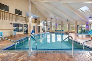 a large indoor swimming pool in a building at AmericInn by Wyndham Delafield-Milwaukee in Delafield