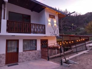 a house with a balcony with lights on it at Къща за гости "НА СЕЛО" Грохотно in Devin