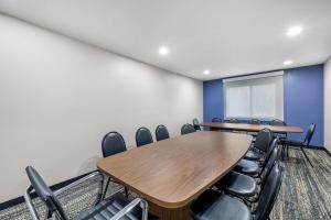 a conference room with a table and chairs at AmericInn by Wyndham Delafield-Milwaukee in Delafield +54 photos