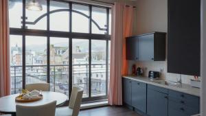 a kitchen with a table and a large window at Seaside Penthouse 1 in Largs +35 photos