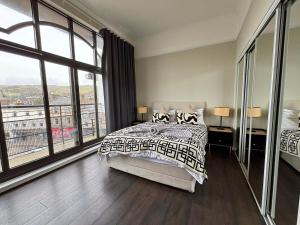 a bedroom with a bed and a large window at Seaside Penthouse 1 in Largs